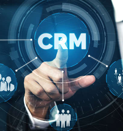 Person's finger pushing a button that says CRM